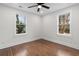 Clean bedroom with hardwood floors, ceiling fan and two windows offering plenty of light at 1226 Pickens St, Hanahan, SC 29410