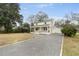 Traditional two-story home featuring a welcoming front porch and a gravel driveway at 1226 Pickens St, Hanahan, SC 29410
