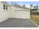 A detached single-car garage features a simple door with decorative sconces on a gravel drive at 1226 Pickens St, Hanahan, SC 29410