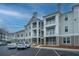 Apartment building with balconies, reserved parking spots and a blue sky background at 130 River Landing Dr # 7123, Charleston, SC 29492
