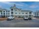 Apartment building with balconies, reserved parking spots and several cars parked in the lot at 130 River Landing Dr # 7123, Charleston, SC 29492