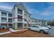 Apartment building with screened porches, and a white truck parked in front at 130 River Landing Dr # 7123, Charleston, SC 29492