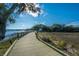 Scenic view of a community boardwalk winding through lush vegetation and leading to waterfront at 130 River Landing Dr # 7123, Charleston, SC 29492
