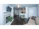 Open-concept living space with fireplace, wood floors, and kitchen view at 130 River Landing Dr # 7123, Charleston, SC 29492