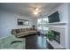 Cozy living room with a decorative fireplace, a ceiling fan and dark wood floors at 130 River Landing Dr # 7123, Charleston, SC 29492