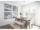 Bright dining room with modern artwork, a rustic wooden table, and elegant decor at 131 Threaded Fern St, Summerville, SC 29485