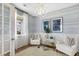 Comfortable sitting area with stylish chairs, hardwood floors, and serene blue accents at 131 Threaded Fern St, Summerville, SC 29485