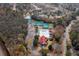 Aerial view of a community pool and clubhouse along with tennis courts in a wooded area at 136 Fair Sailing Rd, Mount Pleasant, SC 29466