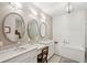 Bright bathroom with dual vanities, soaking tub, shiplap accent wall and modern lighting at 136 Fair Sailing Rd, Mount Pleasant, SC 29466