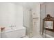 Luxurious bathroom featuring a soaking tub, glass shower, and shiplap walls at 136 Fair Sailing Rd, Mount Pleasant, SC 29466