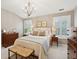 Traditional bedroom with a chandelier, wood furniture, and natural light at 136 Fair Sailing Rd, Mount Pleasant, SC 29466