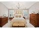 Bright bedroom with chandelier, neutral decor, and classic wooden furnishings at 136 Fair Sailing Rd, Mount Pleasant, SC 29466