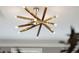 Close-up of a modern, starburst-style chandelier with gold arms and round bulbs against a white ceiling at 136 Fair Sailing Rd, Mount Pleasant, SC 29466