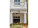 Front entrance featuring a covered porch with white columns, a black door, and trimmed greenery at 136 Fair Sailing Rd, Mount Pleasant, SC 29466