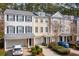 Exterior view of townhomes with garages, driveways, front lawns, and two cars parked in front at 136 Fair Sailing Rd, Mount Pleasant, SC 29466
