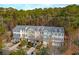 View of townhomes with garages and cars parked in driveways, with lush trees in the background at 136 Fair Sailing Rd, Mount Pleasant, SC 29466