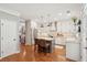 Bright kitchen with an island, stainless steel appliances, white cabinets, hardwood floors, and modern pendant lighting at 136 Fair Sailing Rd, Mount Pleasant, SC 29466
