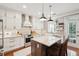 Modern kitchen featuring an island, white cabinets, stainless steel appliances, and stylish lighting at 136 Fair Sailing Rd, Mount Pleasant, SC 29466