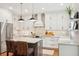 Bright kitchen with an island, stainless steel appliances, white cabinets, and modern pendant lighting at 136 Fair Sailing Rd, Mount Pleasant, SC 29466