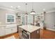 Bright kitchen boasts an island with a marble countertop, stainless steel appliances, and a farmhouse sink at 136 Fair Sailing Rd, Mount Pleasant, SC 29466