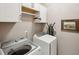 Bright laundry room featuring a washer and dryer, cabinets, and ironing board at 136 Fair Sailing Rd, Mount Pleasant, SC 29466