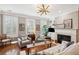 Cozy living room with fireplace, built-in bookshelves, comfortable seating, and abundant natural light at 136 Fair Sailing Rd, Mount Pleasant, SC 29466