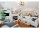 Bright living room featuring a fireplace, built-in shelves, hardwood floors, and stylish decor at 136 Fair Sailing Rd, Mount Pleasant, SC 29466