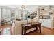 Bright living room featuring hardwood floors, plantation shutters, built-in shelving, and stylish furniture at 136 Fair Sailing Rd, Mount Pleasant, SC 29466