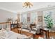 Bright living room with hardwood floors, plantation shutters, stylish furniture, and natural light at 136 Fair Sailing Rd, Mount Pleasant, SC 29466