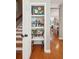View of an organized pantry with wooden floors and white shelving that's close to the staircase at 136 Fair Sailing Rd, Mount Pleasant, SC 29466