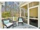 Screened-in porch features chairs, a small table, and views of the trees at 136 Fair Sailing Rd, Mount Pleasant, SC 29466