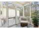 Screened-in porch features a cozy chair and views of the trees at 136 Fair Sailing Rd, Mount Pleasant, SC 29466