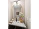 Stylish powder room features a marble countertop, a gold mirror, and modern lighting at 136 Fair Sailing Rd, Mount Pleasant, SC 29466