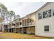 A view of the rear of several townhomes each with an elevated screened in porch and ground level access at 136 Fair Sailing Rd, Mount Pleasant, SC 29466