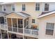 Exterior elevated view of screened in porch with outdoor furniture including couch, chairs and table at 136 Fair Sailing Rd, Mount Pleasant, SC 29466