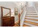 View of the staircase with wood treads, white risers, and wooden banister alongside wood flooring and wall decor at 136 Fair Sailing Rd, Mount Pleasant, SC 29466