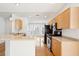 Well-lit kitchen with stainless steel appliances, modern fixtures, and seamless flow into the dining area at 1475 Coopers Hawk Dr, Hanahan, SC 29410