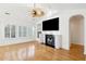 Bright living room with hardwood floors, fireplace, a ceiling fan, and large windows at 1475 Coopers Hawk Dr, Hanahan, SC 29410