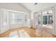 Sunroom filled with natural light, plantation shutters, and sliding glass door to the outdoor living space at 1475 Coopers Hawk Dr, Hanahan, SC 29410