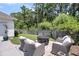 Outdoor patio with comfortable wicker chairs surrounding a fire pit, perfect for entertaining and relaxing at 1710 Sparkleberry Ln, Johns Island, SC 29455