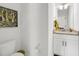 Bright half-bathroom with granite countertop and decorative artwork at 1710 Sparkleberry Ln, Johns Island, SC 29455
