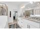 Bright bathroom featuring a double sink vanity with granite countertops and a glass-enclosed shower at 1710 Sparkleberry Ln, Johns Island, SC 29455