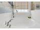 Bright bathtub with a tiled window, perfect for relaxing and creating a spa-like experience at 1710 Sparkleberry Ln, Johns Island, SC 29455