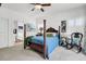 Comfortable bedroom with a four poster bed, ceiling fan, and view into ensuite bathroom at 1710 Sparkleberry Ln, Johns Island, SC 29455
