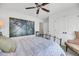Bright bedroom with large wall art, ceiling fan, and wrought iron bed frame at 1710 Sparkleberry Ln, Johns Island, SC 29455