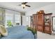 Sunlit bedroom featuring a four poster bed and wooden armoire at 1710 Sparkleberry Ln, Johns Island, SC 29455