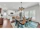 View of dining room with dark wood table, seating for six, and adjacent kitchen with stainless steel appliances at 1710 Sparkleberry Ln, Johns Island, SC 29455