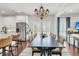 Bright dining room featuring an elegant chandelier, dark wood table, and an eye-catching striped rug at 1710 Sparkleberry Ln, Johns Island, SC 29455