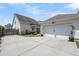 Exterior view featuring the driveway, back of the house, and a garage of the home at 1710 Sparkleberry Ln, Johns Island, SC 29455