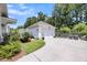Detached two car garage with lush landscaping and additional seating area at 1710 Sparkleberry Ln, Johns Island, SC 29455